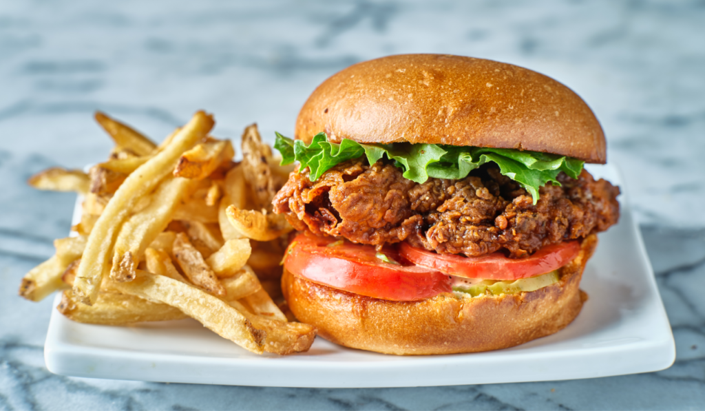 crispy fried chicken sandwich on brioche bun with french fries