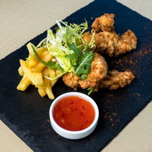 fried chicken and fries on blue ceramic plate